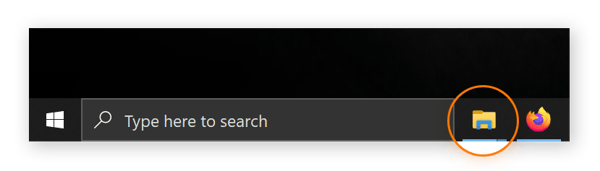 Una captura de pantalla de la barra de tareas con el icono de la carpeta en un círculo. Al hacer clic en ella, se abre el Explorador de archivos.