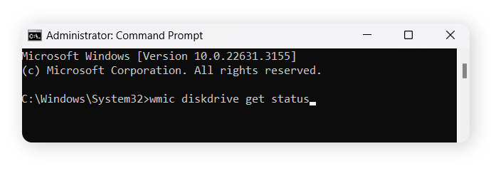 The user has typed "wmic diskdrive get status" into the command prompt.