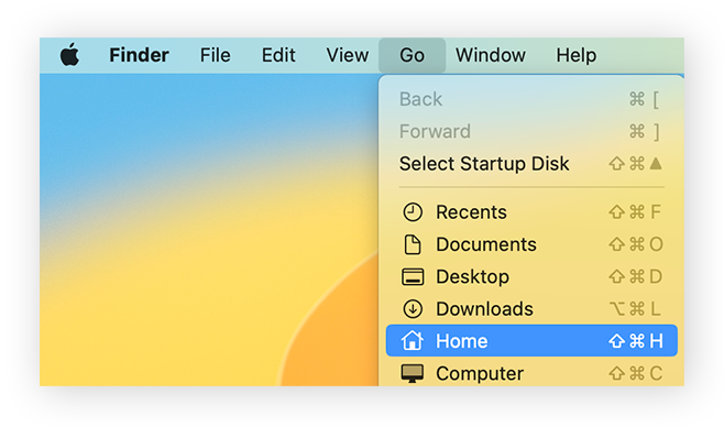 The Go menu in Finder open, with Home selected.