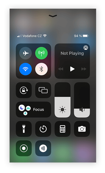 Opening the Control Center on iPhone by swiping up from the bottom of the screen.