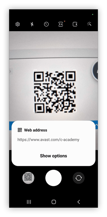 An Android phone scanning a QR code and getting a decoded URL.