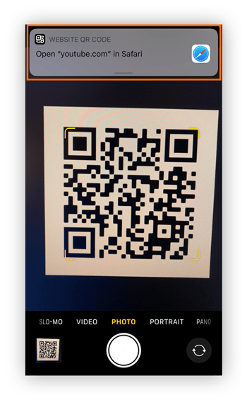 View of QR code in the frame of the iPhone's camera, with the notification at the top circled.