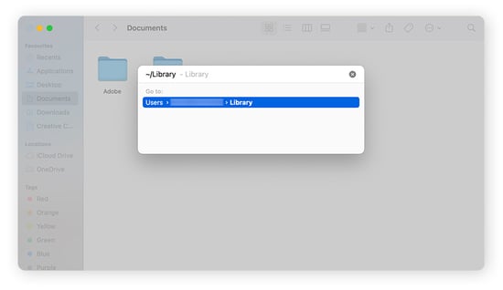 Opening the Library folder from the Go to Folder search bar on macOS Sonoma.